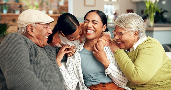 A family hugging and laughing together.