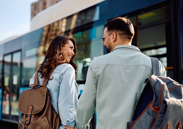 Two passengers approach a bus