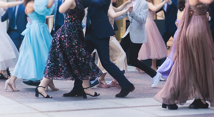 Teens in formal wear dance at a school function