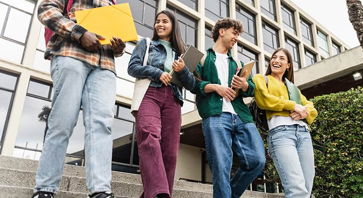 Prospective students walk on a college campus