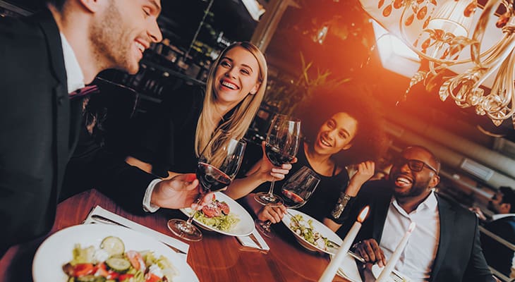 Young adults gather at a nice restaurant for drinks