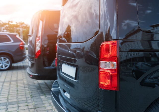 the back of a plain black minibus