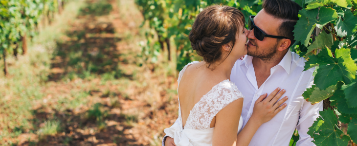 a bride and a groom in a vineyard